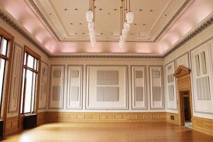 The Ballroom set with round tables under crystal chandeliers
