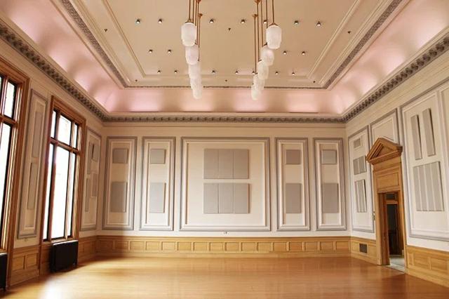 The Ballroom's restored wood columns and arched windows, once a Federal courtroom