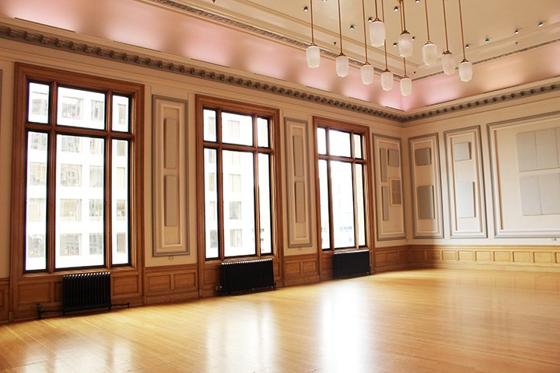 The Ballroom's wood-columned interior with tall arched windows