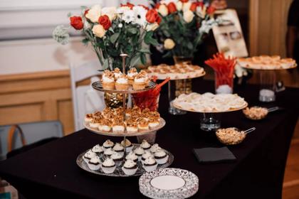 A dessert and floral display table styled for an evening event