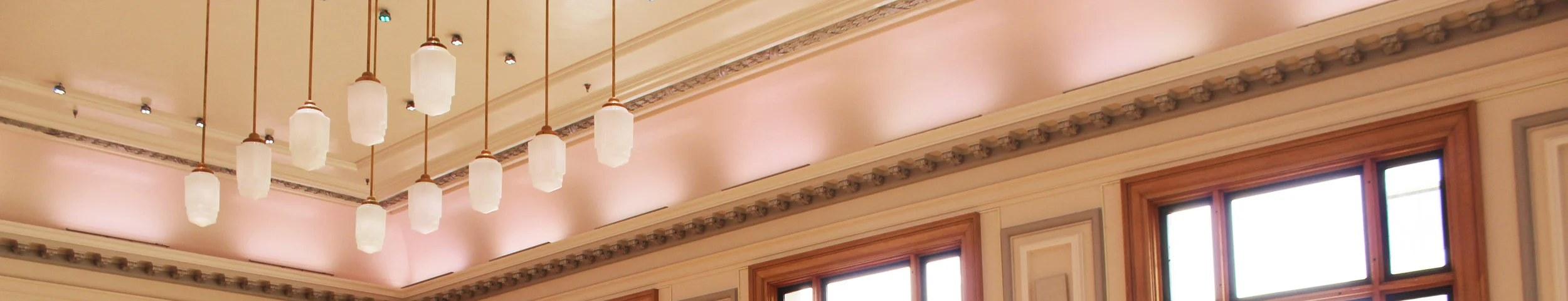 The Ballroom at Court House Square, a restored 2,000 square foot event room with original wood columns and crystal chandeliers