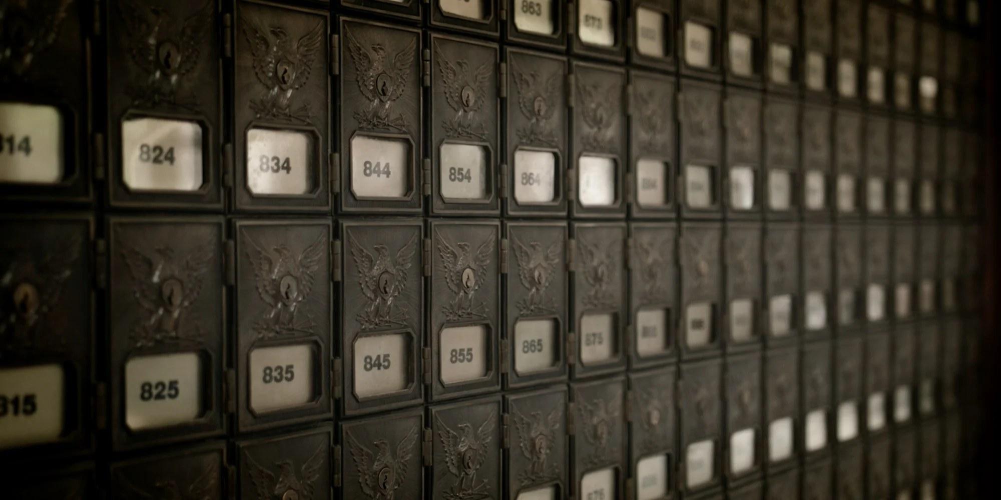 A wall of vintage brass post office boxes inside Court House Square