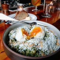 A poached egg dish with greens at en Rama