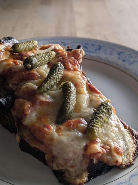 A slice of sandwich with pickles from Not Bad