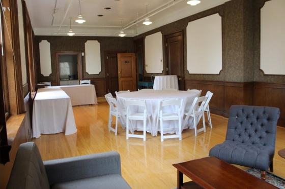 The Parlor set for an evening event with candlelit centerpieces
